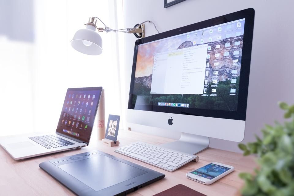 Desktop computer, tablet and laptop on a desk