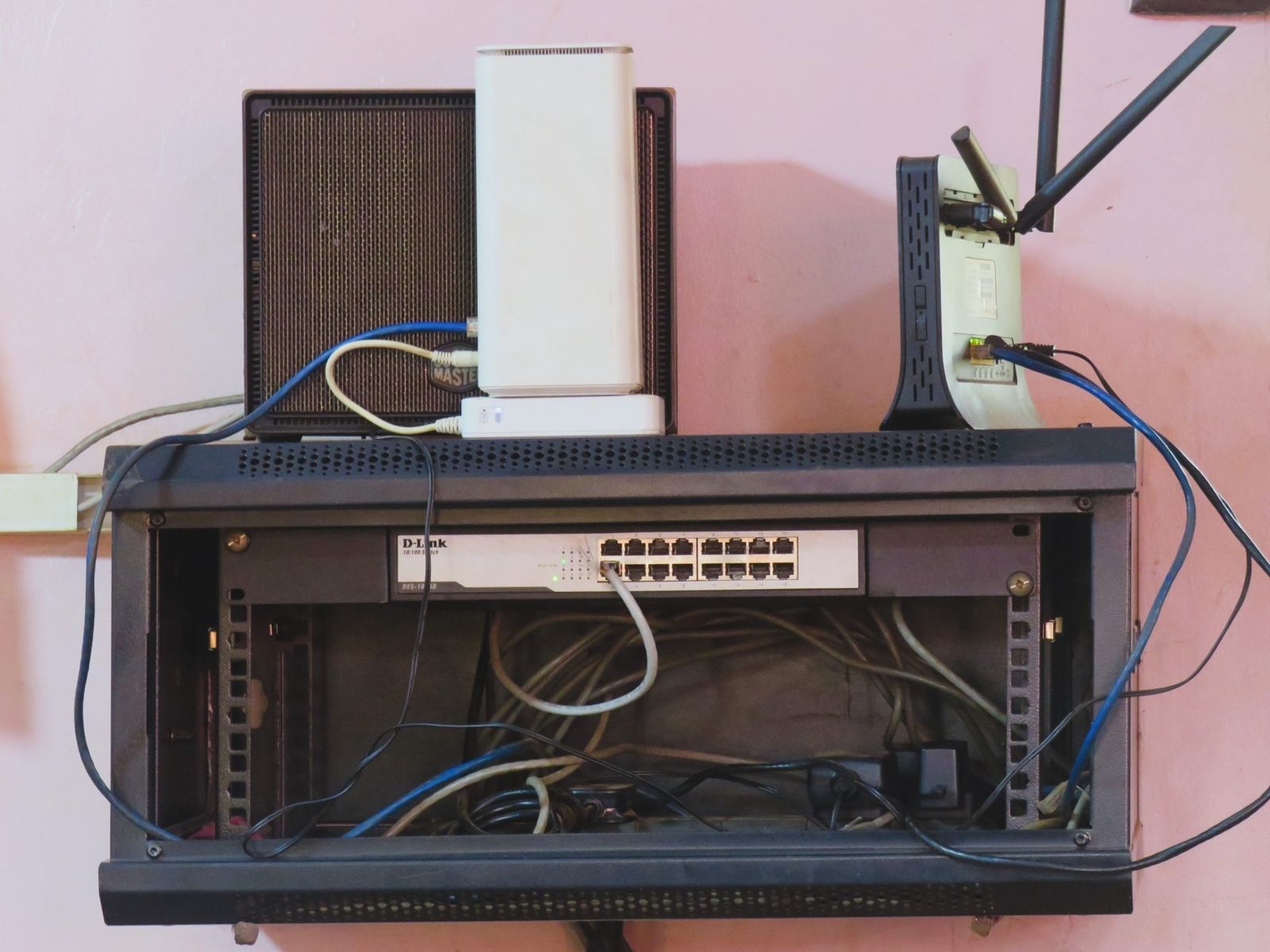 Wall-mounted network cabinet with a router on top